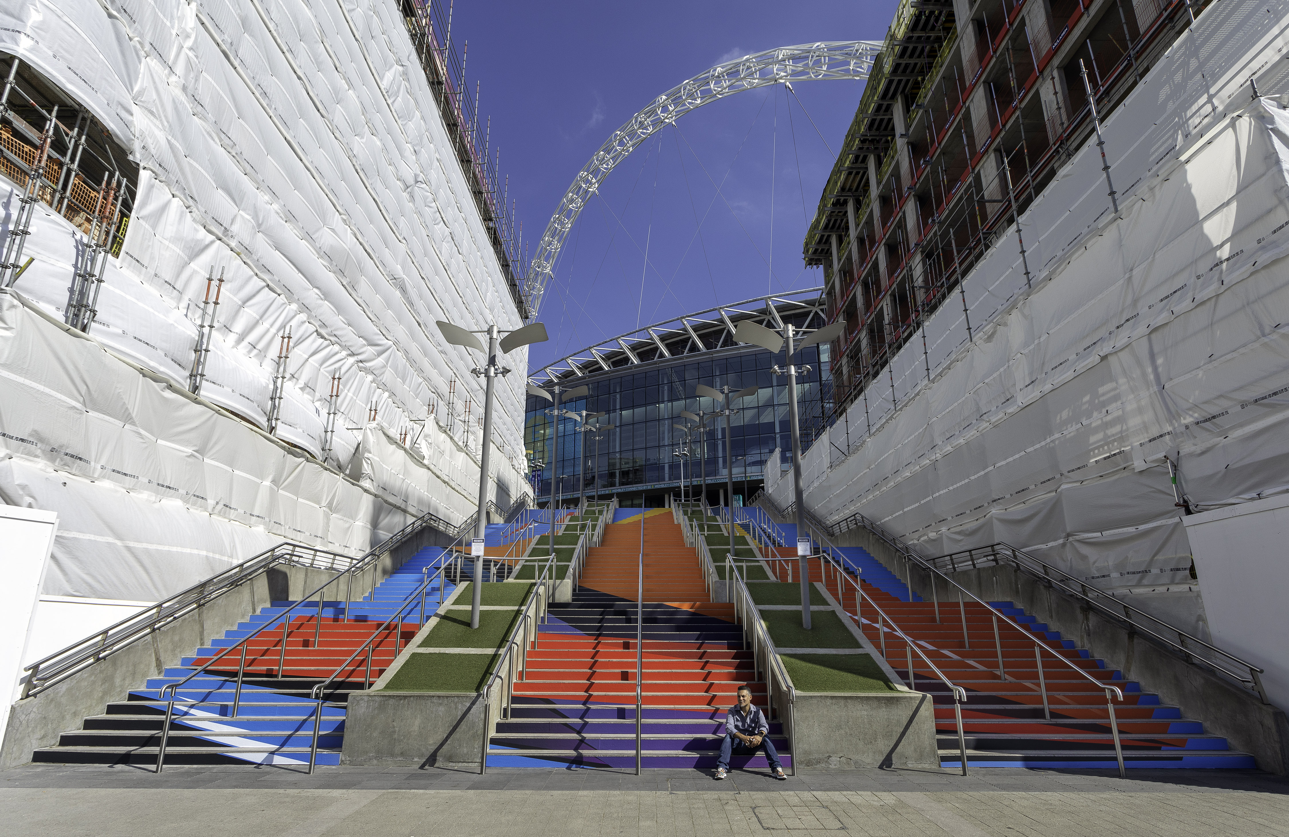 Artist Remi at his design installation at Wembley Park, London. Photo credit : Chris Winter / Wembley Park