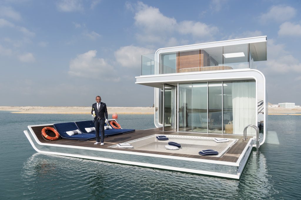 A butler is welcoming the press to a prototype of The Floating Seahorse, an underwater holiday villa, situated at the Heart of Europe, a man-made archipelago 2.5 miles off Dubai. The villa features underwater bedrooms and bathrooms with floor-to-ceiling windows that allow for views of marine life. Each villa comes with a personal butler. By the time the ambitious project is complete there will be more than 125 floating villas, which cost as much as 2,5 million Euro each. Renting the villa will cost 5,000 Euro a day. This photograph is part of the series ‘Dubai. Bread and Circuses’, a documentary on leisure and tourism in Dubai.