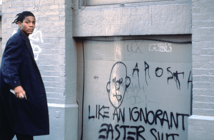 ‘THESE INSTITUTIONS HAS THE MOST POLITICAL INFLUENCE A.TELEVISION B. THE CHURCH C. SAMO D. MC DONALDS’, Jean-Michel Basquiat on the set of Downtown 81. © New York Beat Film LLC. By permission of The Estate of Jean-Michel Basquiat. Photo: Edo Bertoglio