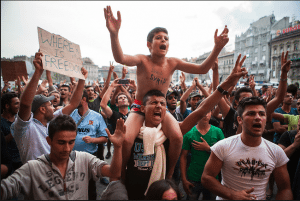 Refugees demonstrate outside Keleti Train Station, Budapest against the cancellation of international trains to Austria and Germany, 2015. © Antonio Olmos.