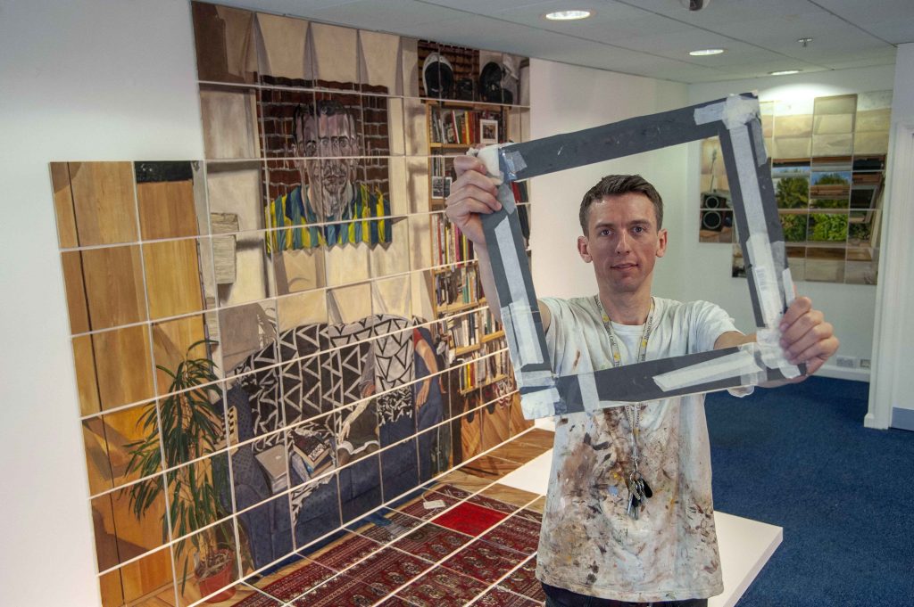 Artist Rod Kitson with viewfinder he used to make his 190 1sq ft paintings