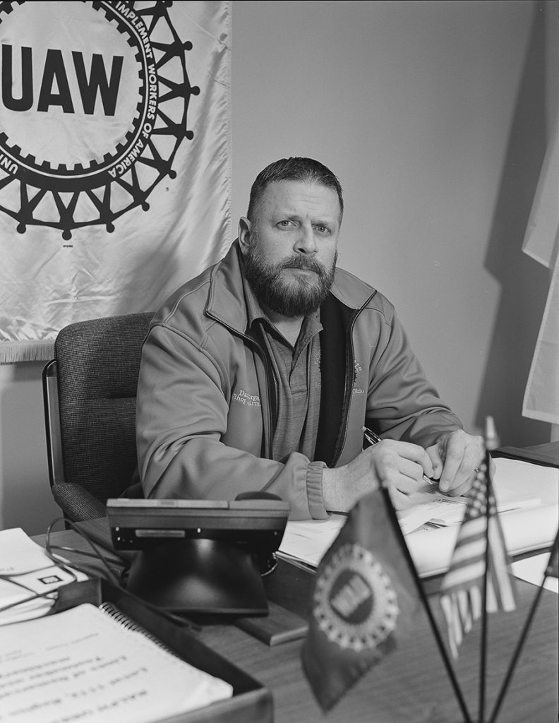 CAPTION: Dan Morgan, Local 1112 Shop Chairman, in his office at UAW Local 1112 Reuther, Scandy, Alli union hall (25 years in at GM Lordstown Assembly, trim shop), Lordstown OH PHOTOS: COURTESY OF LATOYA RUBY FRAZIER AND GAVIN BROWN’S ENTERPRISE NEW YORK/ROME CAPTION FOR IMAGE BELOW: Kesha Scales hugging Beverly Williams in her living room (22 years in at GM Lordstown Assembly, pressroom),