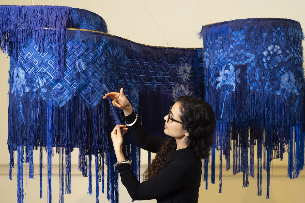 Artist Kamilah Ahmed with her artwork The Life Above at Collect 2026.