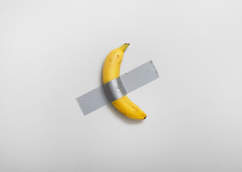 MAURIZIO CATTELAN’S “COMEDIAN” THAT DUCT-TAPED BANANA just sold for $6.2