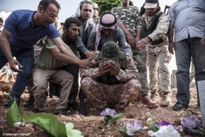 Mourners, Kobane, 2015 and 2016. Kobane was liberated in January 2015 but the conflict carried on in the surrounding areas. The Kurdish fighters bring their dead back to Kobane for burial. © Maryam Ashrafi.