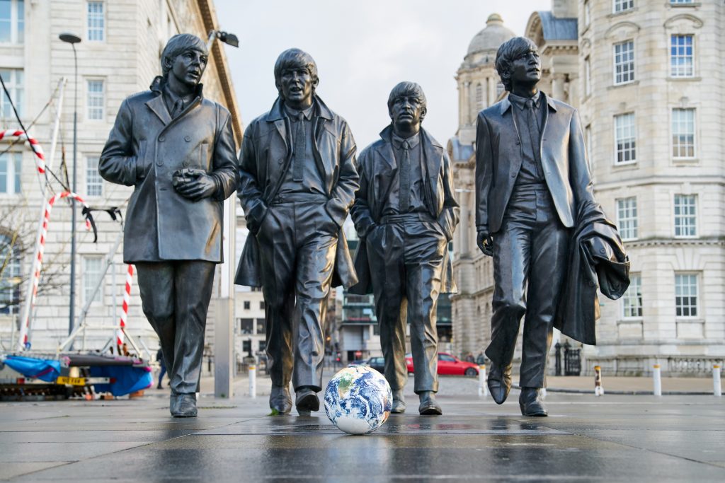 One World football at the Beatles statue in Liverpool. Photo by Rob Battersby