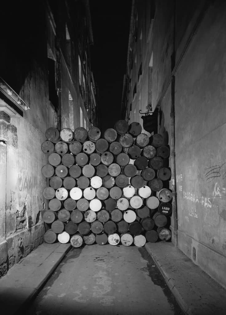 CHRISTO AND JEANNE-CLAUDE Wall of Oil Barrels—The Iron Curtain, Rue Visconti, Paris, 1961–62 Not included in the exhibition. © Christo and Jeanne-Claude Foundation Photo: Jean-Dominique Lajoux Courtesy Gagosian