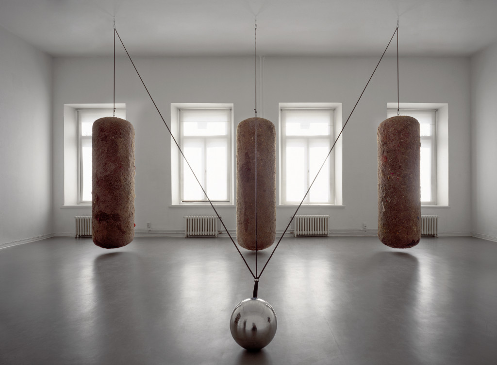 Timo Heino,Gravitation, 1999. House dust, rubber, stainless steel, lead shots, steel ball Ø 30 cm, three dust bales, 210 cm x 60 cm each