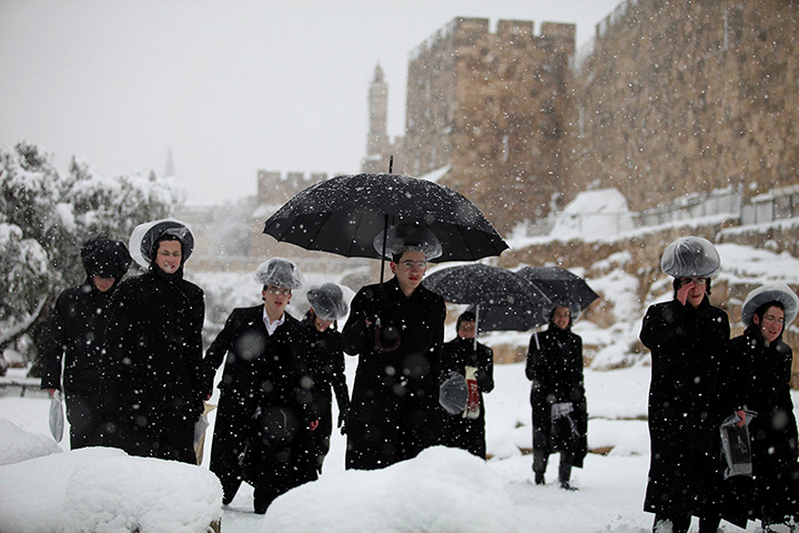 Ultra-Orthodox Jews walk along the Old City walls
