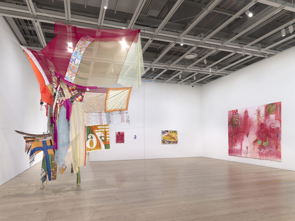 Installation view of the Whitney Biennial 2019 (Whitney Museum of American Art, New York, May 17-September 22, 2019). From left to right: Eric N. Mack, Proposition: for wet Gee’s Bend Quilts to replace the American flag – Permanently., 2019; Jennifer Packer, Untitled, 2019; Jennifer Packer, An Exercise in Tenderness, 2017; Jennifer Packer, Untitled, 2019; Jennifer Packer, A Lesson in Longing, 2019. Photograph by Ron Amstutz