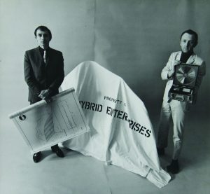 Peter Phillips and Gerald Laing with a covered Hybrid sculpture, blueprint, and research kit, New York, 1966;
