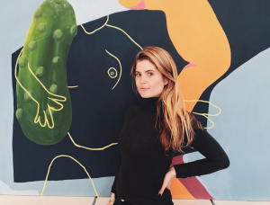Founder & CEO Katharina Wenzel-Vollenbroich in front of a work by Billy Parker available on ARTPIQ, student at Slade School, London