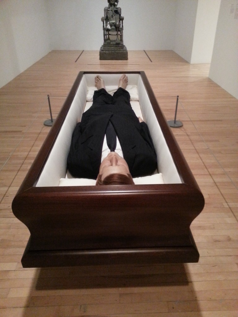 Maurizio Cattelan Now 2004. Polyester resin wax pigment human hair clothing and coffin.