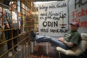 Gerrit, a former criminal, speaks with visitors from his cage at the "Human ZOO" performance event in the cultural centre of Kampnagel in Hamburg